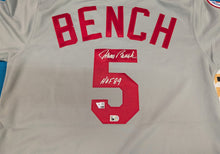 A light gray baseball jersey showing the back side with 'BENCH' in large red letters and the number 5 in red, signed in white marker and featuring a small authentication sticker.